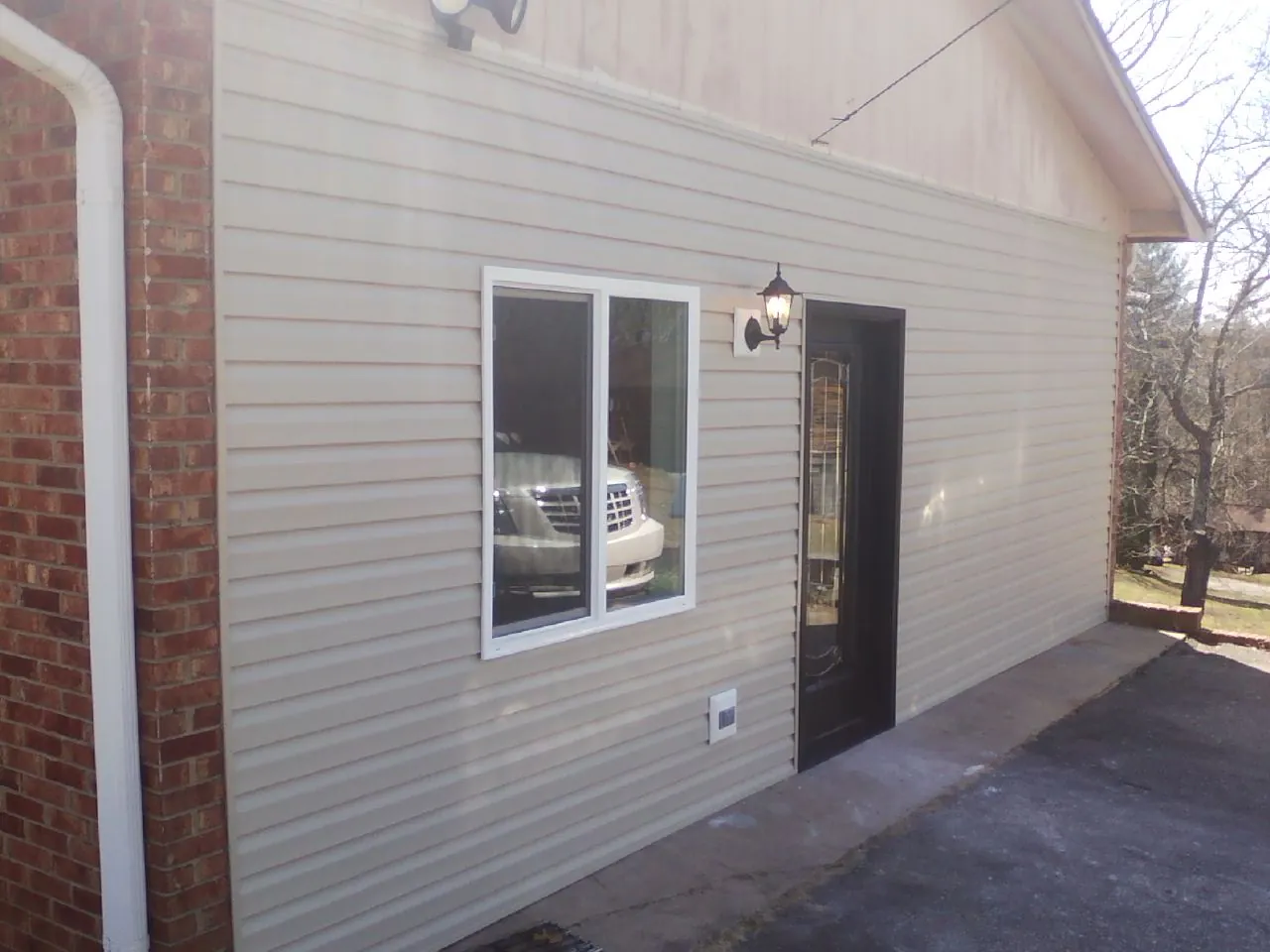 New vinyl siding and entry door on a room addition in Clearfield
