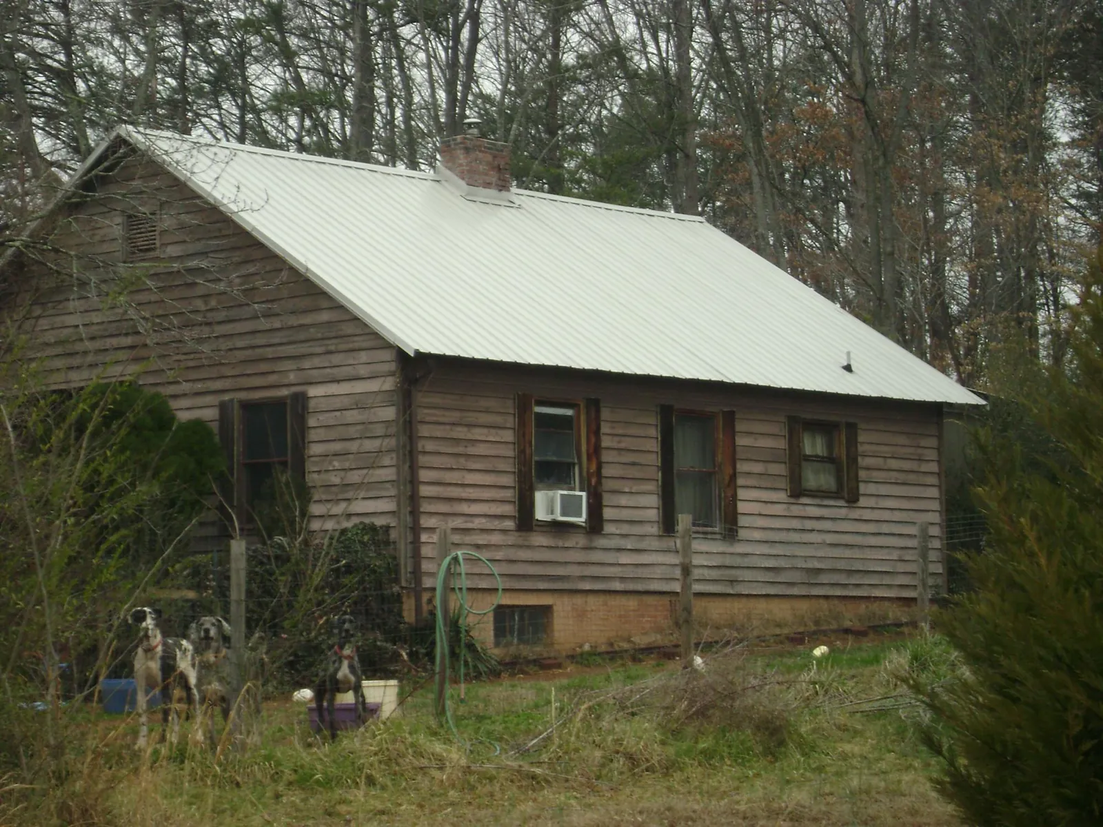 White metal roof on an old wood sided farmhouse, from a Metal Roof Installation job in Clearfield